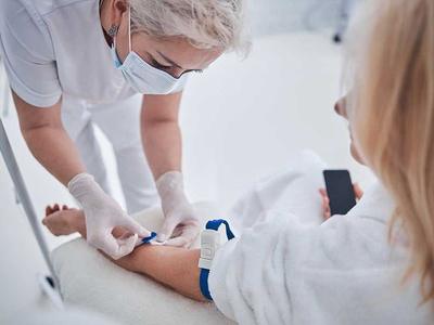 A nurse preparing a patient's arm for a blood draw