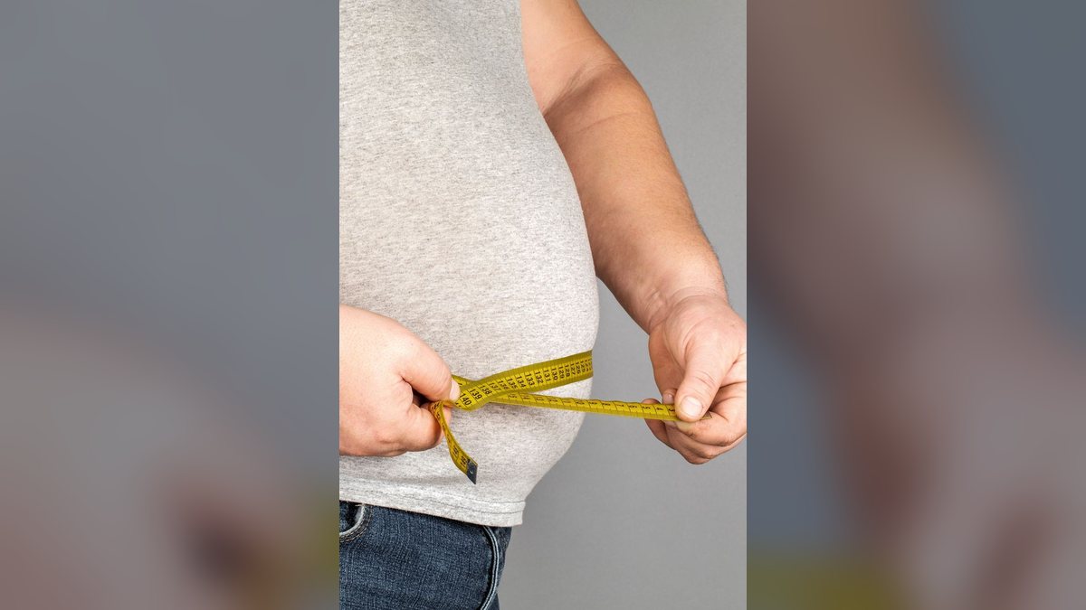 A tape measure around a man's waist