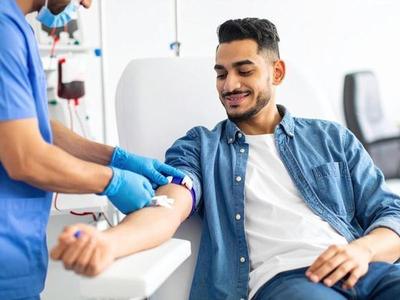 A patient having blood drawn by a phlebotomist